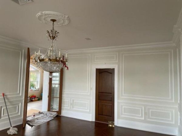 Dining room with painted wainscoting and crown moulding