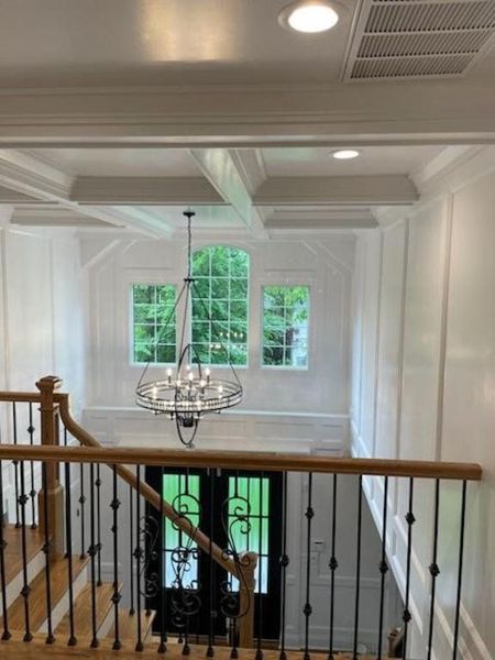 Foyer with coffered ceiling and painted trim