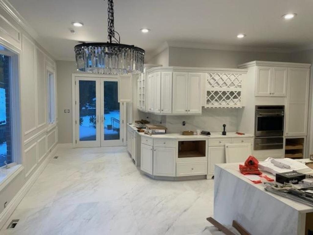 Kitchen with freshly painted white cabinetry and trim